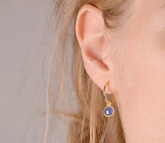 Thin gold hoop earrings with blue sapphire